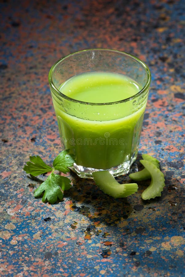 Glass of juice of celery and greens, top view, vertical. Glass of juice of celery and greens, top view, vertical