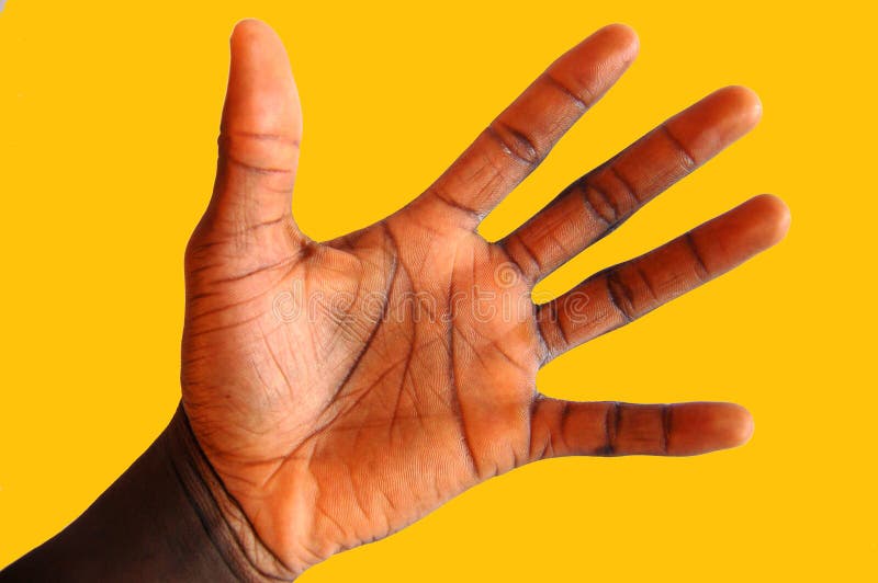 This is an image of a black hand waving against an amber background to get attention. This is an image of a black hand waving against an amber background to get attention.