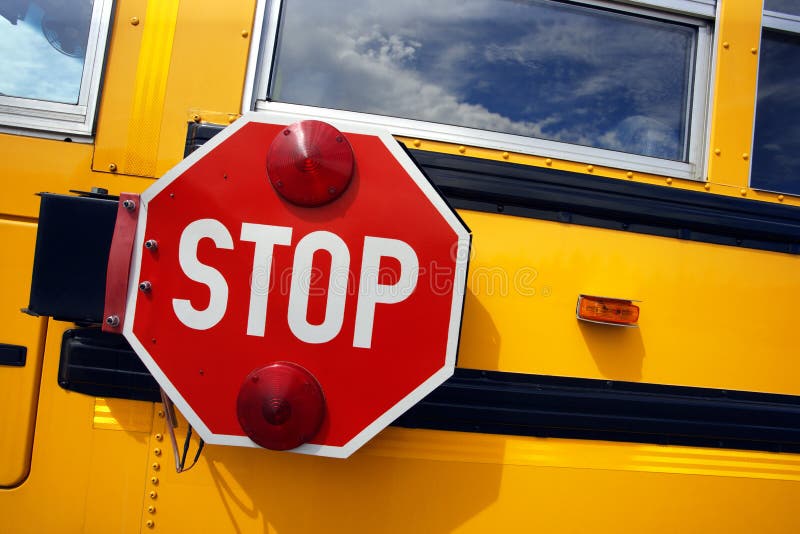 Side view of a school bus and its stop signal. Side view of a school bus and its stop signal.