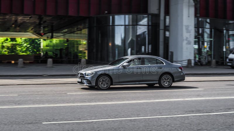 Moscow, Russia - July 2021: Mercedes E Class W213 Facelift on the city road. Fast moving glossy gray auto on Moscow streets. Shiny premium Mercedes-Benz side view. Moscow, Russia - July 2021: Mercedes E Class W213 Facelift on the city road. Fast moving glossy gray auto on Moscow streets. Shiny premium Mercedes-Benz side view