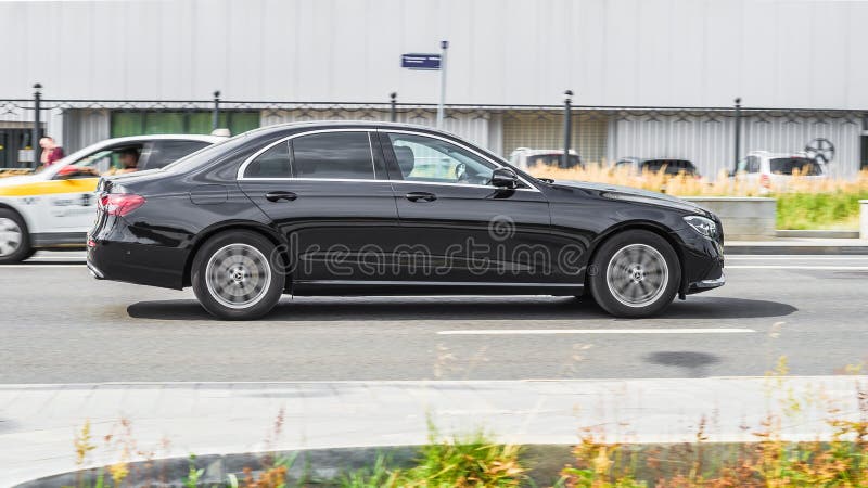 Moscow, Russia - July 2021: Mercedes E class 300d driving on the city main road. Mercedes-Benz W213 facelift in black color rushing down the street. Moscow, Russia - July 2021: Mercedes E class 300d driving on the city main road. Mercedes-Benz W213 facelift in black color rushing down the street