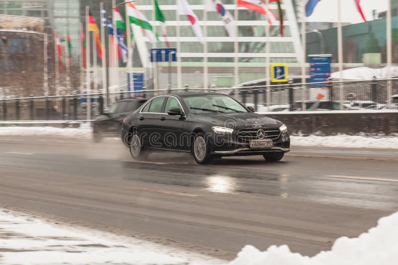 Moscow, Russia - 7 December 2021: Mercedes E Class w213 facelift car in motion on winter slippery road. Moscow, Russia - 7 December 2021: Mercedes E Class w213 facelift car in motion on winter slippery road