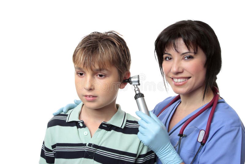 A doctor checks a boys ears with an otoscope (auroscope). A doctor checks a boys ears with an otoscope (auroscope)