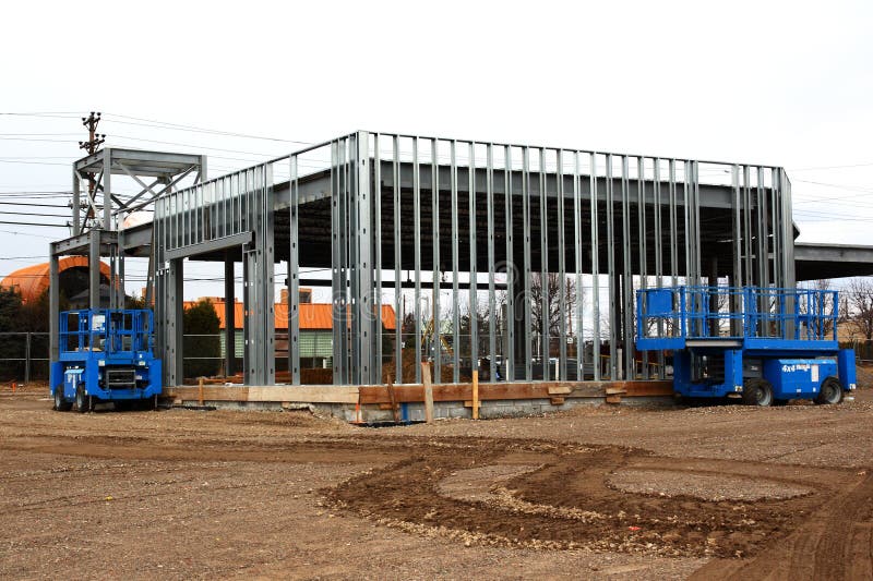 Automotive repair shop being built by steel frame. 2 high low equipment parked outside. Automotive repair shop being built by steel frame. 2 high low equipment parked outside.