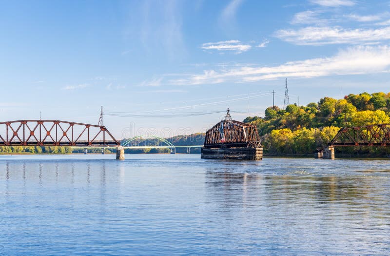 Dubuque Railroad bridge opens to allow river cruise boat to pass on Upper Mississippi in Dubuque Iowa. Dubuque Railroad bridge opens to allow river cruise boat to pass on Upper Mississippi in Dubuque Iowa