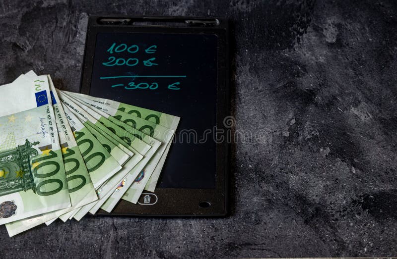 100 Euro banknotes spread on the table paying taxes inflation in Europe. 100 Euro banknotes spread on the table paying taxes inflation in Europe