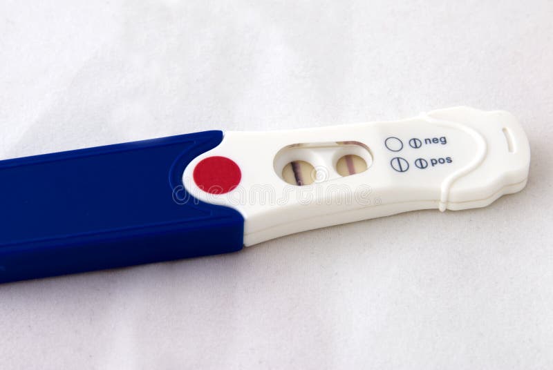 Hand holding a positive pregnancy test. Hand holding a positive pregnancy test
