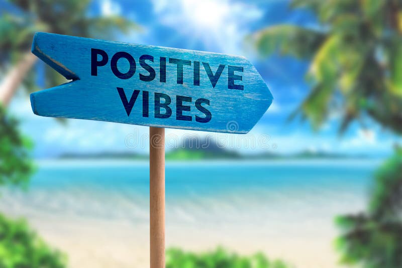 Positive vibes sign board arrow on beach with sunshine background. Positive vibes sign board arrow on beach with sunshine background