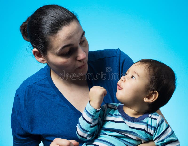 Studio shot of mother who holding her 2 years old boy. Studio shot of mother who holding her 2 years old boy.