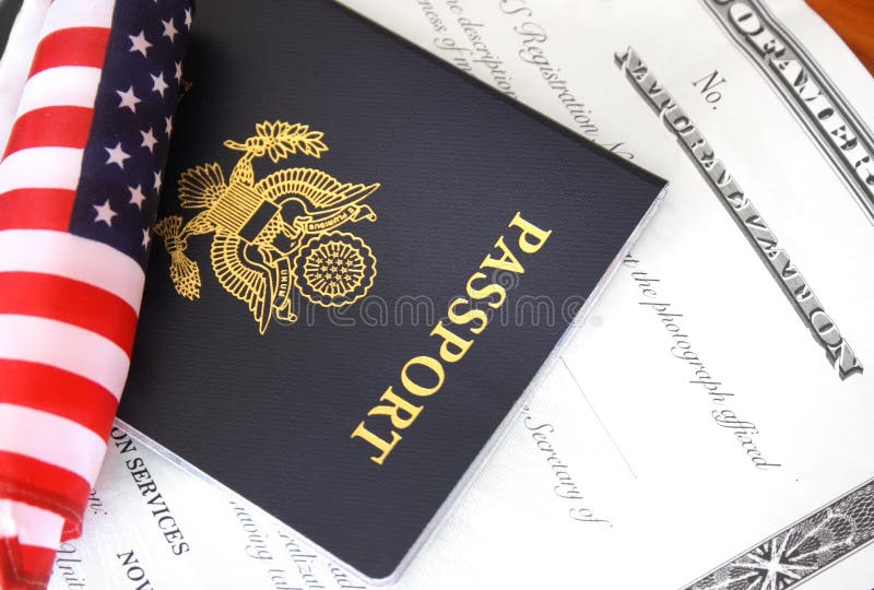 Immigration concept, US passport and flag over a citizenship and naturalization certificate. Immigration concept, US passport and flag over a citizenship and naturalization certificate