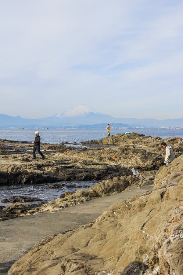 2013.01.06, Kamakura, Japan. Auto trip around famous places of Japan.fishermen on the rocks of Enoshima. 2013.01.06, Kamakura, Japan. Auto trip around famous places of Japan.fishermen on the rocks of Enoshima