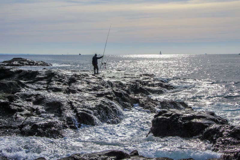 2013.01.06, Kamakura, Japan. Auto trip around famous places of Japan.fishermen on the rocks of Enoshima. 2013.01.06, Kamakura, Japan. Auto trip around famous places of Japan.fishermen on the rocks of Enoshima