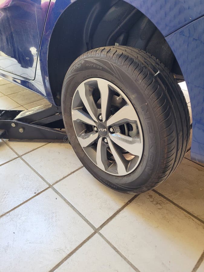 Guadalajara, Mexico - March 17 2024: A car tire is shown with a black and white wheel. Guadalajara, Mexico - March 17 2024: A car tire is shown with a black and white wheel