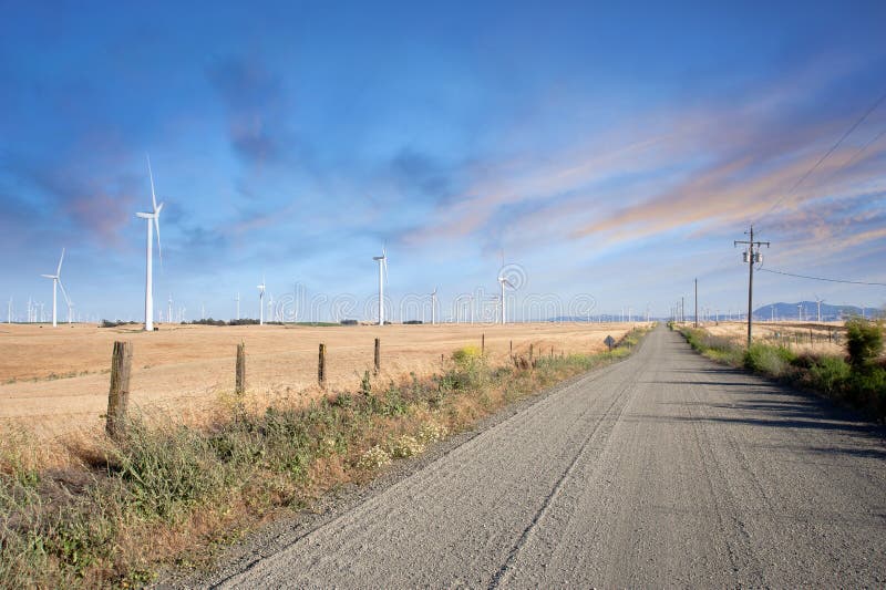 Desert Road through Wind Turbines Farm in California Sunset, Renewable Energy. Desert Road through Wind Turbines Farm in California Sunset, Renewable Energy