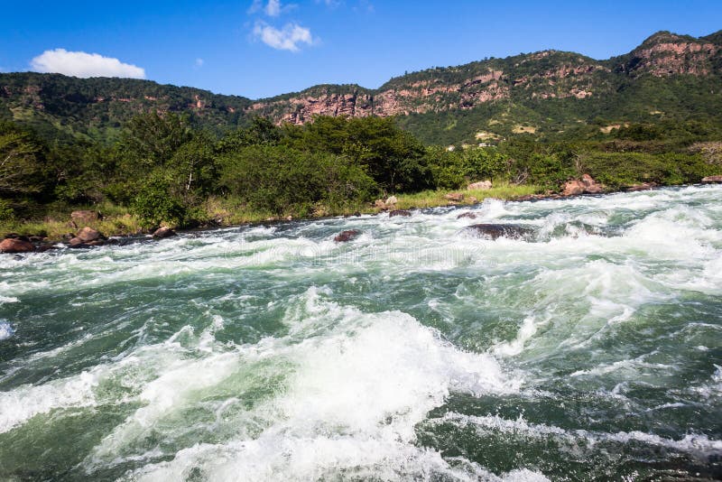 River water rock rapids rushing flow of water energy and power. River water rock rapids rushing flow of water energy and power