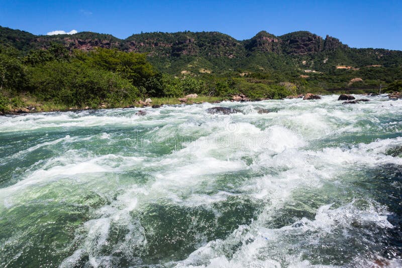 River water rock rapids rushing flow of water energy and power. River water rock rapids rushing flow of water energy and power