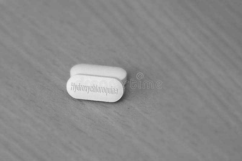 治疗疟疾的羟氯喹片药物及COVID 19冠状病毒特写新药治疗 治疗 免版税库存照片 治疗疟疾的羟氯喹片药物及COVID 19冠状病毒特写新药治疗 治疗 免版税库存照片