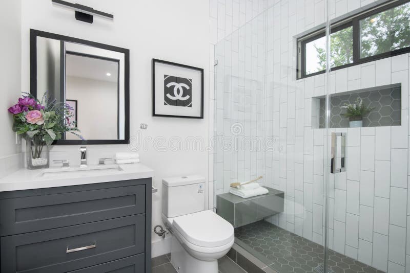 A compact bathroom with toilet, sink, and shower area in a modern new construction home in Los Angeles. A compact bathroom with toilet, sink, and shower area in a modern new construction home in Los Angeles