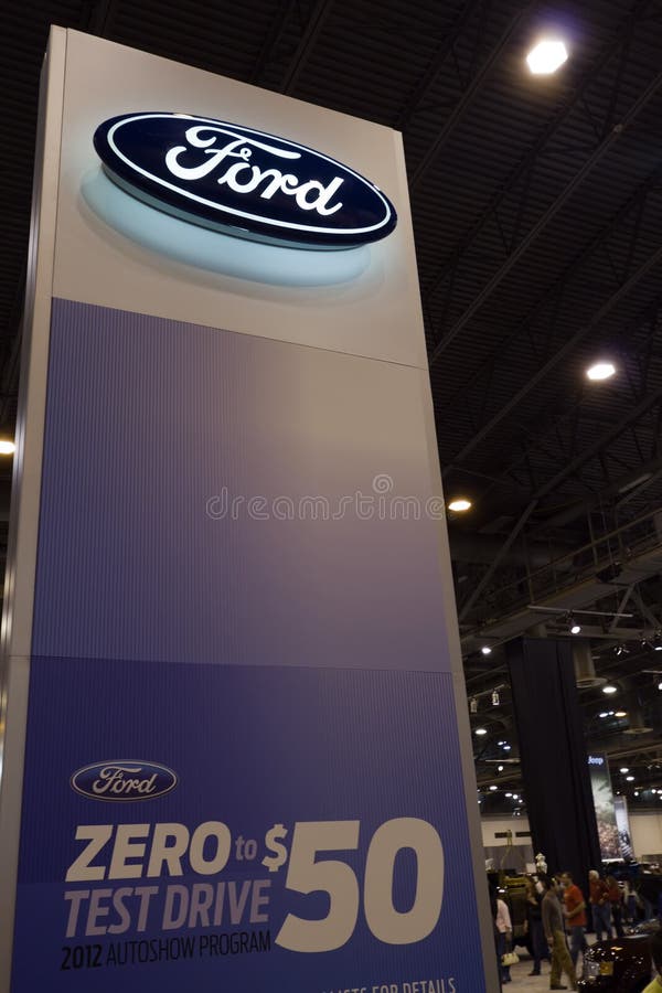 HOUSTON - JANUARY 2012: A Ford sign at the Houston International Auto Show on January 28, 2012 in Houston, Texas. HOUSTON - JANUARY 2012: A Ford sign at the Houston International Auto Show on January 28, 2012 in Houston, Texas.