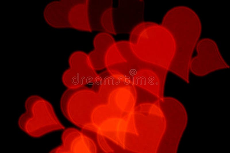 Romantic red hearts on black background. Abstract love background. Romantic red hearts on black background. Abstract love background.