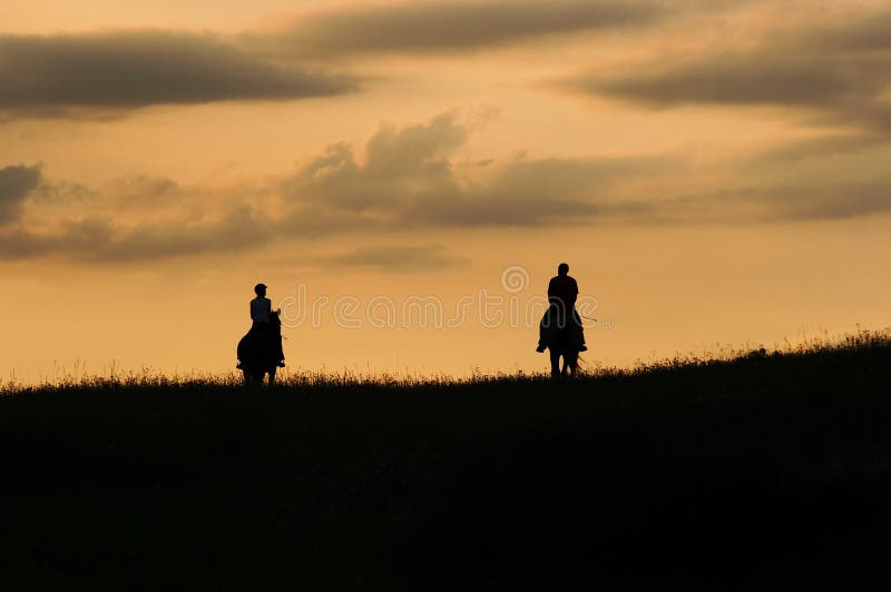 Image of the romantic horseback ride - couple on the horses. Image of the romantic horseback ride - couple on the horses