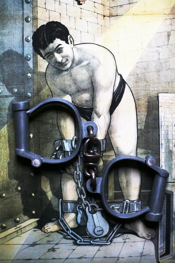 High security handcuffs as used by the police in UK with chain and Harry Houdini portrait on poster. High security handcuffs as used by the police in UK with chain and Harry Houdini portrait on poster