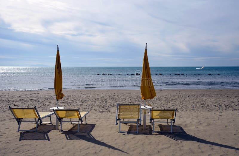 Seascape with deckchair and closed beach-umbrella. Seascape with deckchair and closed beach-umbrella
