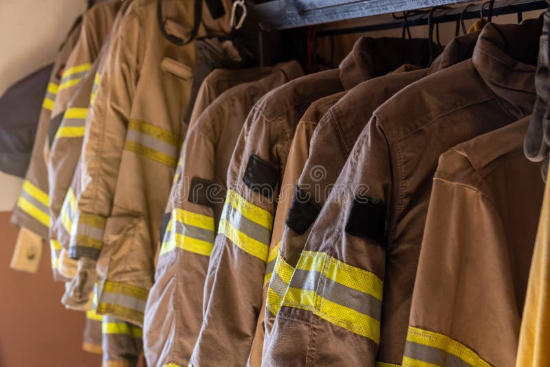 Firefighter`s uniforms and gear arranged at fire station. Firefighter`s uniforms and gear arranged at fire station.