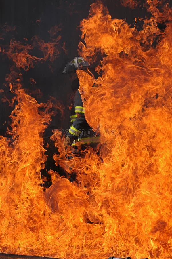 Firefighter with safety gear at burning house. Firefighter with safety gear at burning house