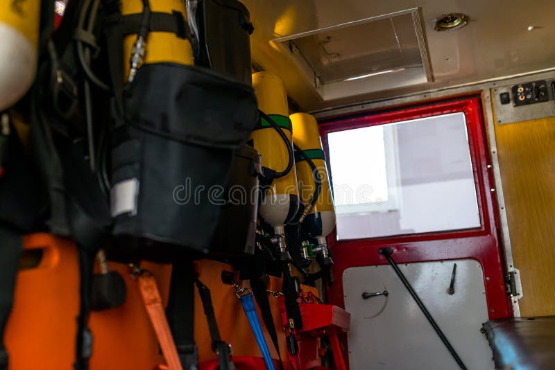 Yellow oxygen cylinders for firefighters, placed in an old fire truck. Yellow oxygen cylinders for firefighters, placed in an old fire truck