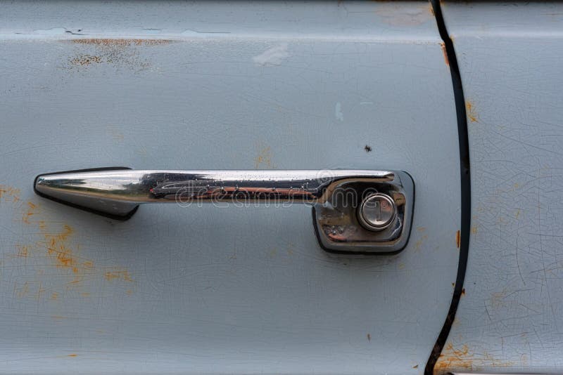 Vintage push button door styled handle on a light blue car. High quality photo. Vintage push button door styled handle on a light blue car. High quality photo