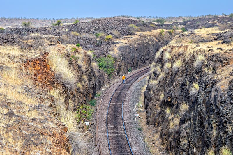 Track-mans routine inspection of a single, non-electrified railway track in deep hill cutting. Track-mans routine inspection of a single, non-electrified railway track in deep hill cutting.