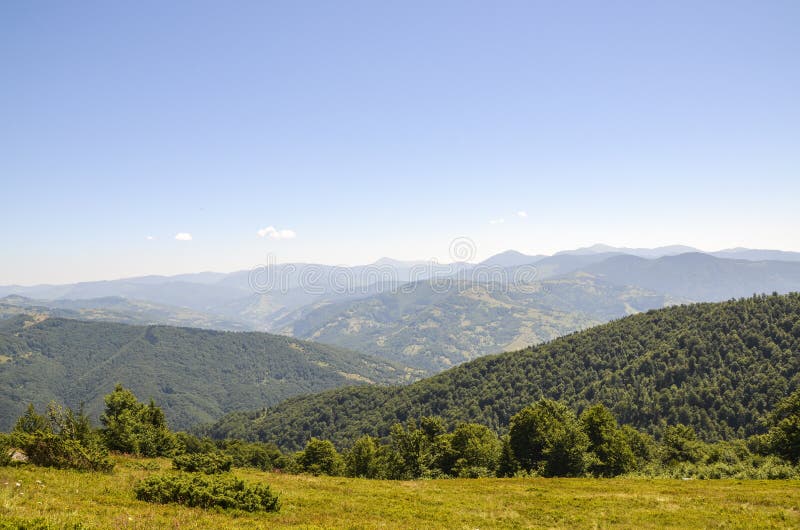 清澈蓝天下，青山起伏的宁静山景 图库摄影