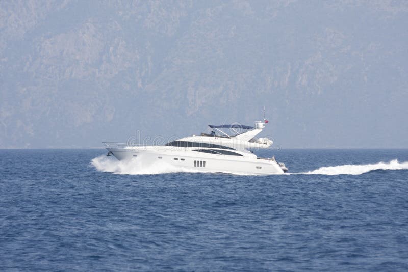 Luxury white motor yacht cruising. Luxury white motor yacht cruising