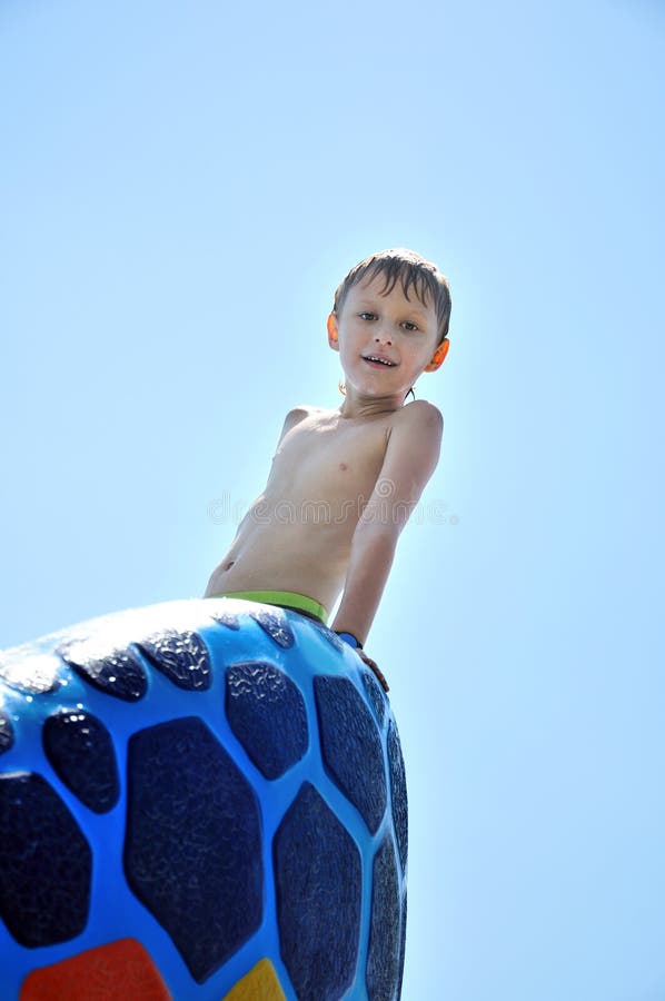 Little wet boy wants to get out from swimming pool. Little wet boy wants to get out from swimming pool