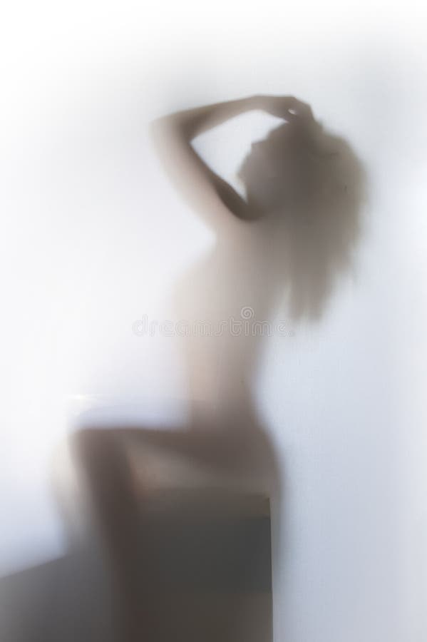 Sexy human female body silhouette sits on bathtub behind a diffuse surface. Sexy human female body silhouette sits on bathtub behind a diffuse surface.
