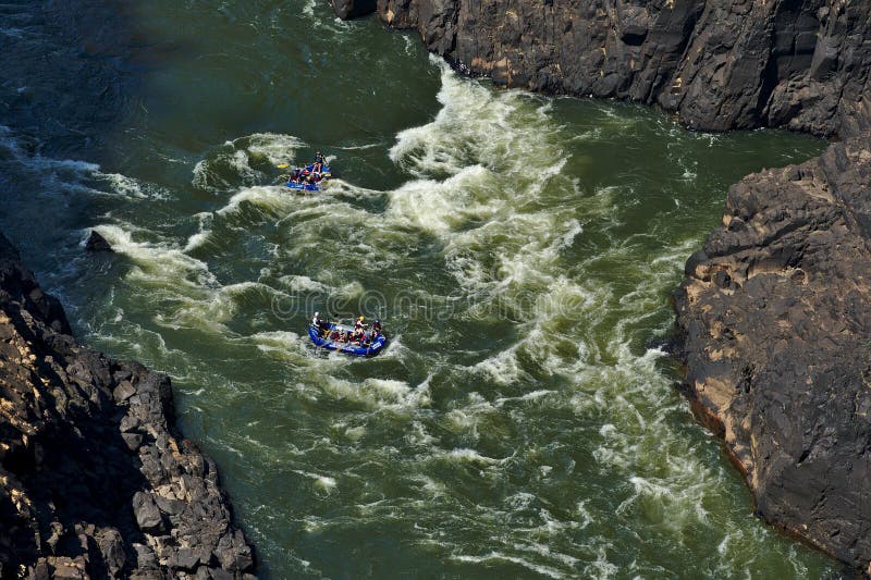 Rafting on Zambezi river. Victoria Falls, Zimbabwe. Inflatable boats in the rapids. Extreme sport. Rafting on Zambezi river. Victoria Falls, Zimbabwe. Inflatable boats in the rapids. Extreme sport.