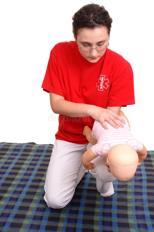 First aid demonstration series - first aid instructor demonstrating on Infant dummy how to rescue the baby from suffocation. First aid demonstration series - first aid instructor demonstrating on Infant dummy how to rescue the baby from suffocation