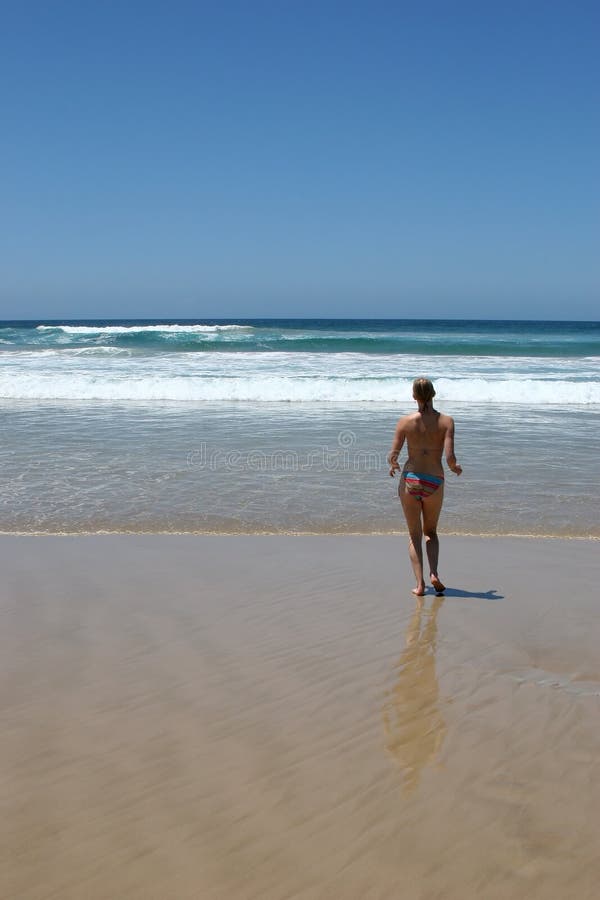 Woman jogging on beach Lennox Head AUstralia. Woman jogging on beach Lennox Head AUstralia