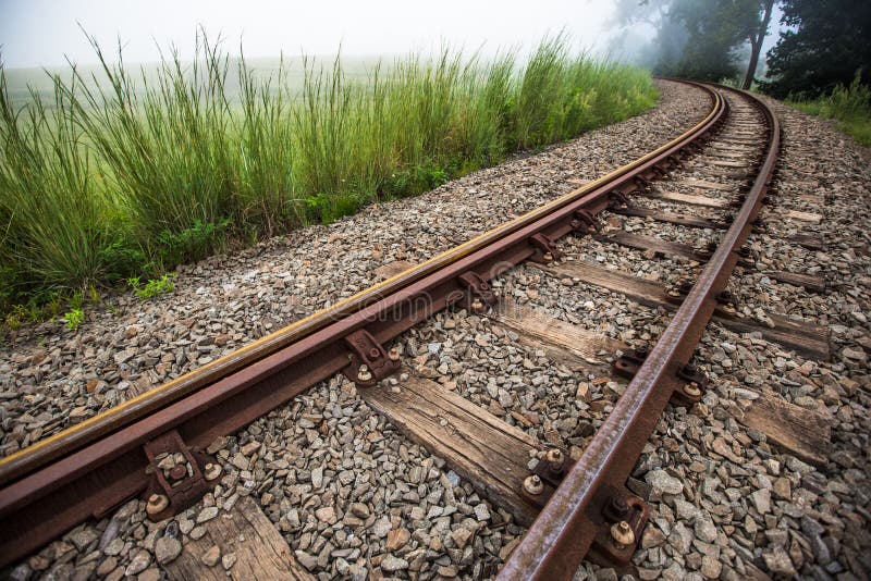 Train tracks curves of into the distance. Train tracks curves of into the distance.