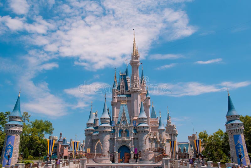 Orlando, Florida. May 17, 2019. Panoramic view of Cinderella`s Castle on cloudy lightblue sky background  in Magic Kingdom at Walt Disney World Resort 2. Orlando, Florida. May 17, 2019. Panoramic view of Cinderella`s Castle on cloudy lightblue sky background  in Magic Kingdom at Walt Disney World Resort 2