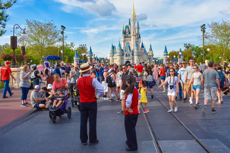 Orlando, Florida. March 19, 2019. Panoramic view of Cinderella`s Castle  and people walking on main street in Magic Kingdom at Walt Disney World . Orlando, Florida. March 19, 2019. Panoramic view of Cinderella`s Castle  and people walking on main street in Magic Kingdom at Walt Disney World .