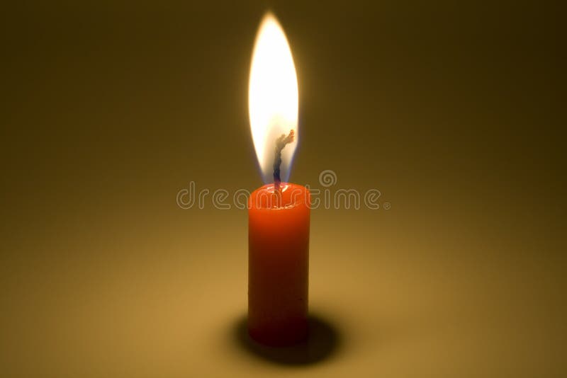 The red candle is burning in the dark. The red candle is burning in the dark