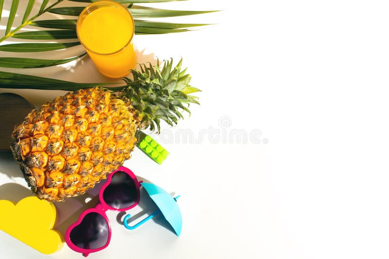 Hot summer season vacation holiday, fresh drink fruit pineapple juice, palm coconut leaf tree, sunglasses, umbrella, flat lay top view. Hot summer season vacation holiday, fresh drink fruit pineapple juice, palm coconut leaf tree, sunglasses, umbrella, flat lay top view