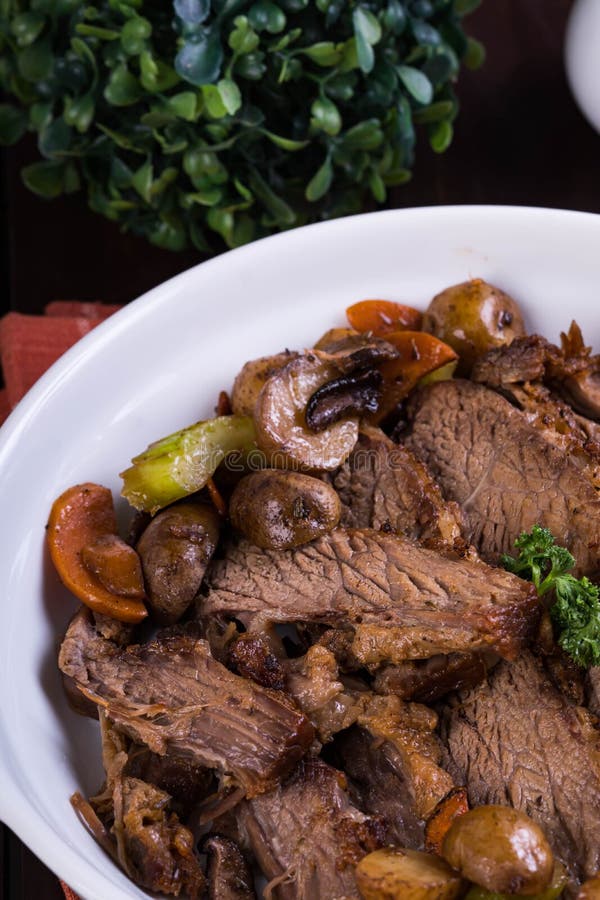 Delicious roast beef with roasted potato, carrots, celery and shiitake mushroom. Delicious roast beef with roasted potato, carrots, celery and shiitake mushroom