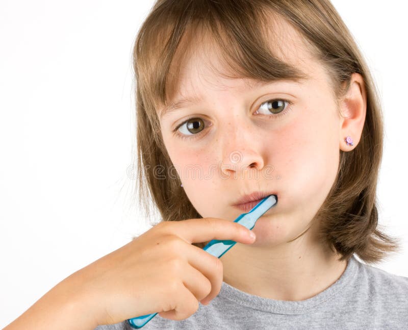 Girl brushing her teeth against a white background. Girl brushing her teeth against a white background