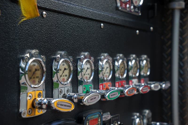 Close-up fire truck equipment detail. Fire control panel, dials and dashboard. Close-up fire truck equipment detail. Fire control panel, dials and dashboard.