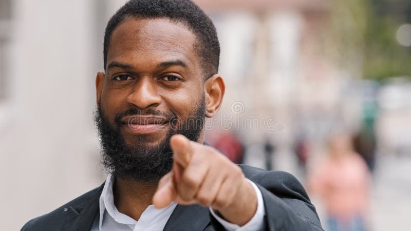 Close up ethnic African American man entrepreneur employer male HR manager CEO businessman in city outdoors pointing with forefinger direction to camera hey you support agree gesture choosing sign. High quality photo. Close up ethnic African American man entrepreneur employer male HR manager CEO businessman in city outdoors pointing with forefinger direction to camera hey you support agree gesture choosing sign. High quality photo