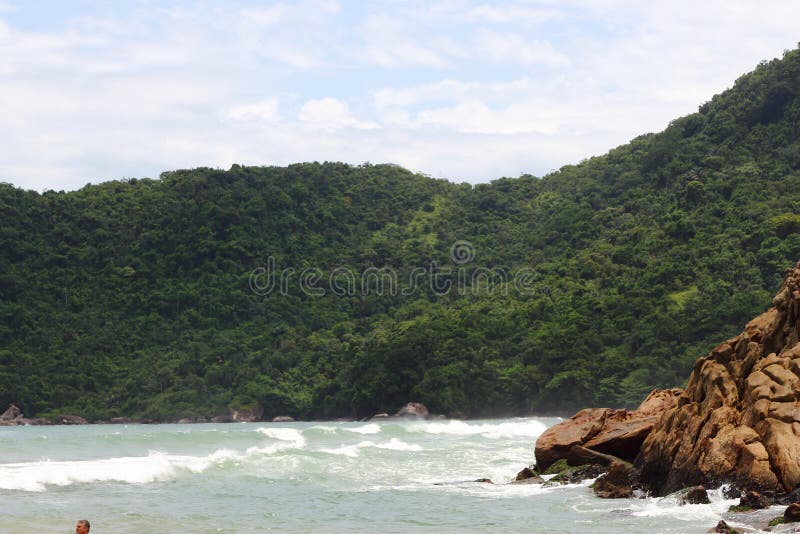 Trindade, Paraty/Rio de Janeiro/Brazil - 01-19-2020: Praia do Meio beach. Strong waves, dangerous sea, drowning risk. Sorrounded by many rocks. Trindade, Paraty/Rio de Janeiro/Brazil - 01-19-2020: Praia do Meio beach. Strong waves, dangerous sea, drowning risk. Sorrounded by many rocks