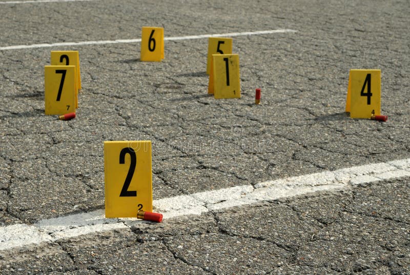 Numbered placards at crime scene with evidence. Numbered placards at crime scene with evidence.